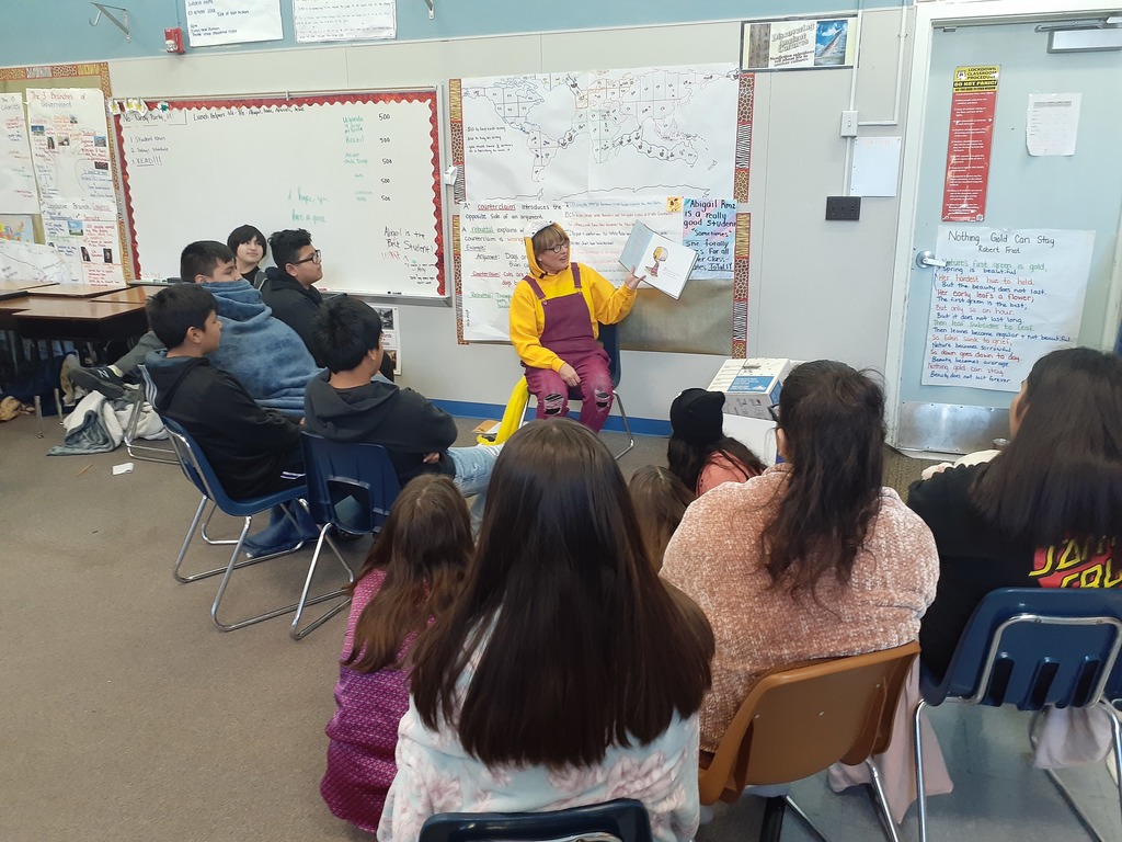 Ms.Stemler reading to the 8th grade class